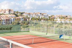 a tennis court with a tennis racket on it at Aldiana Club Costa del Sol in Alcaidesa