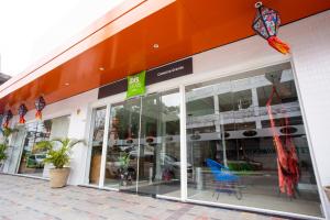 a store front with glass doors and a sign on it at ibis Styles Campina Grande in Campina Grande