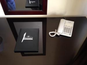 a phone sitting on a wall next to a box and a phone at Shanasheel Palace Hotel in Baghdad