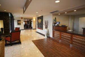 a lobby with a waiting area with chairs and a bar at Red Lion Inn & Suites Olympia, Governor Hotel in Olympia