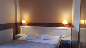Postel nebo postele na pokoji v ubytování Hotel Olympic