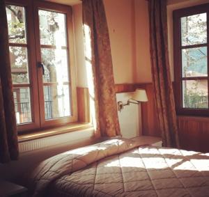 Postel nebo postele na pokoji v ubytování Hotel Olympic
