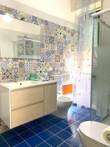 a bathroom with a toilet and a sink and a tub at Mille tramonti Agropoli sunset suite in Agropoli +45 photos