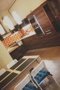 eine Küche mit 2 Stühlen, einem Tisch und einer Theke in der Unterkunft W&M Stylish Apartment in Budapest