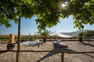 a hammock in the sand under a tree at Provence Birtok in Decs