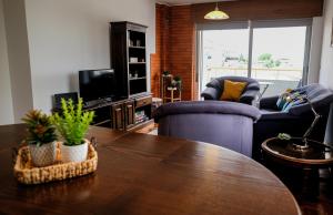 a living room with a table and chairs and a tv at Cozy 3 Room Apartment in Penafiel Centre in Penafiel