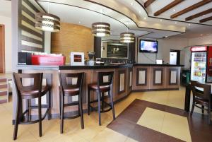 a bar in a fast food restaurant with stools at Acropolis Hotel in Pazardzhik