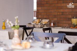 a table with chairs and vases on top of it at Pousada do Gui-Gui Aeroporto in Goiânia