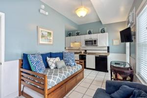 a living room with a couch and a kitchen at Colors on White in Key West