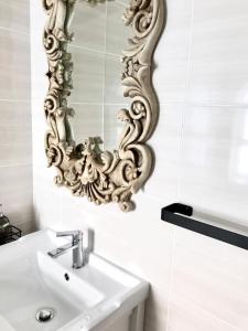 a bathroom with a sink and a mirror on the wall at Posto Al Sole - IL Bacio in Bellville