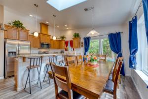 a kitchen with a wooden table and blue curtains at The Captain's Quarters in Rockaway Beach