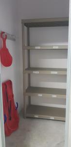 a book shelf with a red bag in a closet at NUEVO APARTAMENTO en Sierra Nevada CON GARAJE e IMPRESIONANTES VISTAS in Sierra Nevada