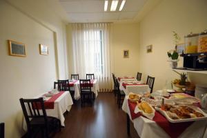 una habitación con mesas y sillas con comida. en B&B Marbò Florence, en Florencia