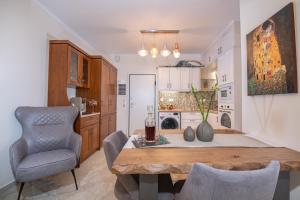 a kitchen and dining room with a table and a chair at Casa Aelia, luxury apartment in Corfu