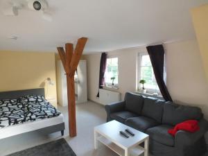 a living room with a couch and a bed at Waldblick in Alt Schwerin