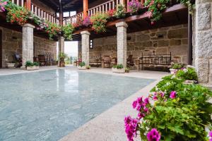 an indoor pool with flowers in a building at Pazo de Esposende in Esposende