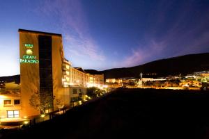 a building with a sign on the side of it at night at Gran Paradiso Hotel Spa in San Giovanni Rotondo