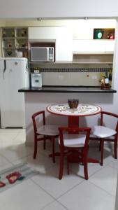 a kitchen with a table and two chairs and a table at Mar Azul in Solemar