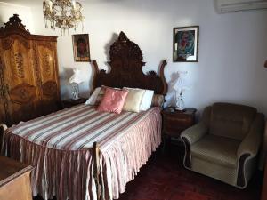 a bedroom with a large bed and a chair at OceanOasis Residences Suites in Olhão +61 photos