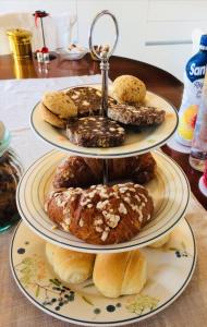 three plates of donuts and pastries on a table at B&B Corte dei Cedri in Bussolengo