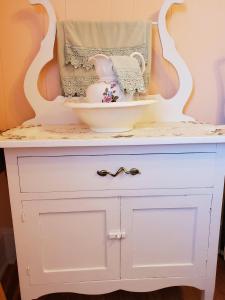 a white dresser with a bowl on top of it at Hillside B&B in Twillingate