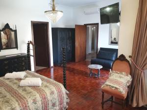 a living room with a bed and a couch at OceanOasis Residences Suites in Olhão