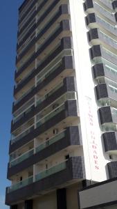 a tall building with a sign on the side of it at Mar Azul in Solemar