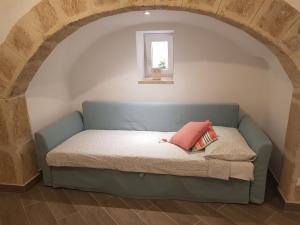 ein Sofa in einem Zimmer mit Fenster in der Unterkunft Casa Arco della Chicca in Monopoli