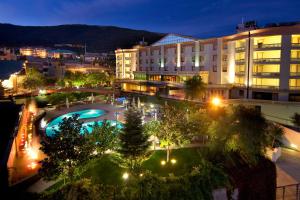 - une vue sur un hôtel la nuit avec une piscine dans l'établissement Gran Paradiso Hotel Spa, à San Giovanni Rotondo