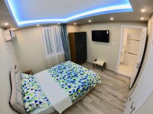 a bedroom with a bed and a television in it at PASHA APART~BOUTİQUE HOTEL/YALOVA in Yalova