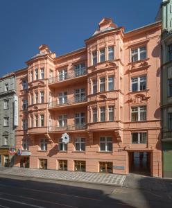 a large brick building in front of a street at Hotel Taurus in Prague