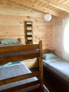 a bedroom with two bunk beds in a cabin at CasaLoft Caicai in Licán Ray