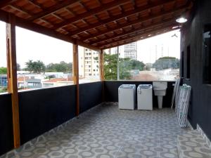 a balcony with two refrigerators and a toilet at Visto Hostel in Sao Paulo