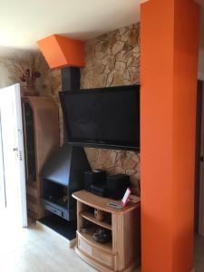 a living room with a flat screen tv and a fireplace at Denia Playa III in Denia
