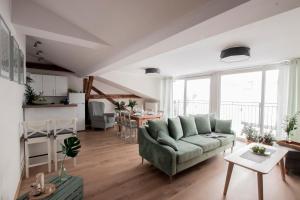 a living room with a couch and a table at Apartamenty KDN in Bielsko-Biała