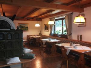 a restaurant with tables and chairs in a room at B&B Seppi in Cavalese