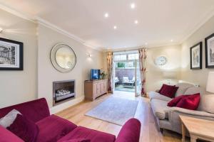 a living room with a couch and a fireplace at ALTIDO Luxury 2 bed,2 bath flat with patio, near Calton Hill in Edinburgh