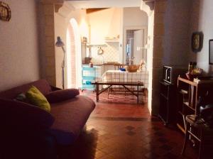 a living room with a couch and a table at Casa del Nespolo sul Mare, Santa Maria la Scala in Acireale