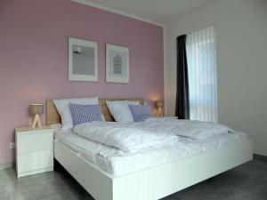 Postel nebo postele na pokoji v ubytování Apartment HEIMATHAFEN, Am Alten Deich 14/1