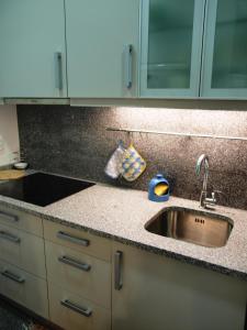 a kitchen with a sink and a counter top at 107 Rosario, Guesthouse in Porto