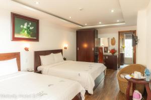 Postel nebo postele na pokoji v ubytování Melody Hotel