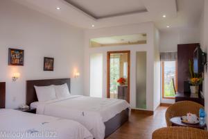 Postel nebo postele na pokoji v ubytování Melody Hotel