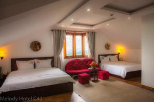 Postel nebo postele na pokoji v ubytování Melody Hotel