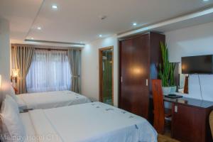 Postel nebo postele na pokoji v ubytování Melody Hotel