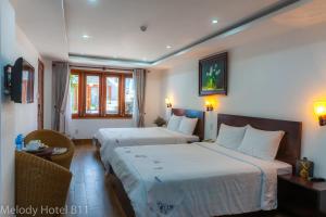 Postel nebo postele na pokoji v ubytování Melody Hotel
