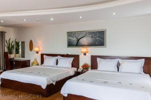 Postel nebo postele na pokoji v ubytování Melody Hotel