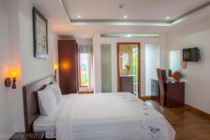 Postel nebo postele na pokoji v ubytování Melody Hotel