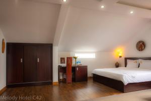Postel nebo postele na pokoji v ubytování Melody Hotel