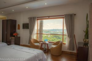 Postel nebo postele na pokoji v ubytování Melody Hotel