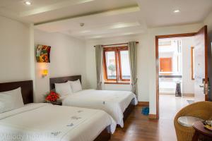 Postel nebo postele na pokoji v ubytování Melody Hotel